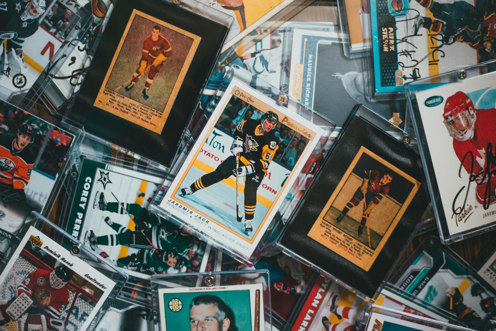 Sports card value lookup photo showing real hockey cards in protective cases
